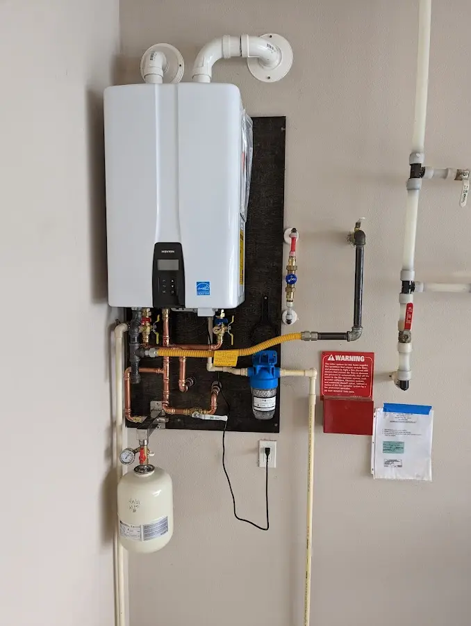 Professional plumber installing copper piping in a Hinesville home